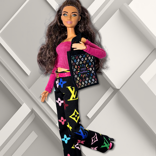 11.5" Barbie fashion doll wearing a casual outfit with a patterned tote bag, pink top, and black, wide- leg pants with a designer- inspired print on a geometric background.