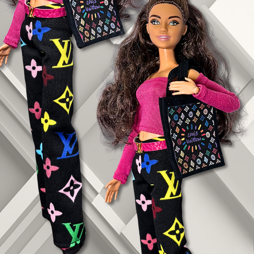Close up of 11.5" Barbie fashion doll wearing a casual outfit with a patterned tote bag, pink top, and black, wide- leg pants with a designer- inspired print on a geometric background.